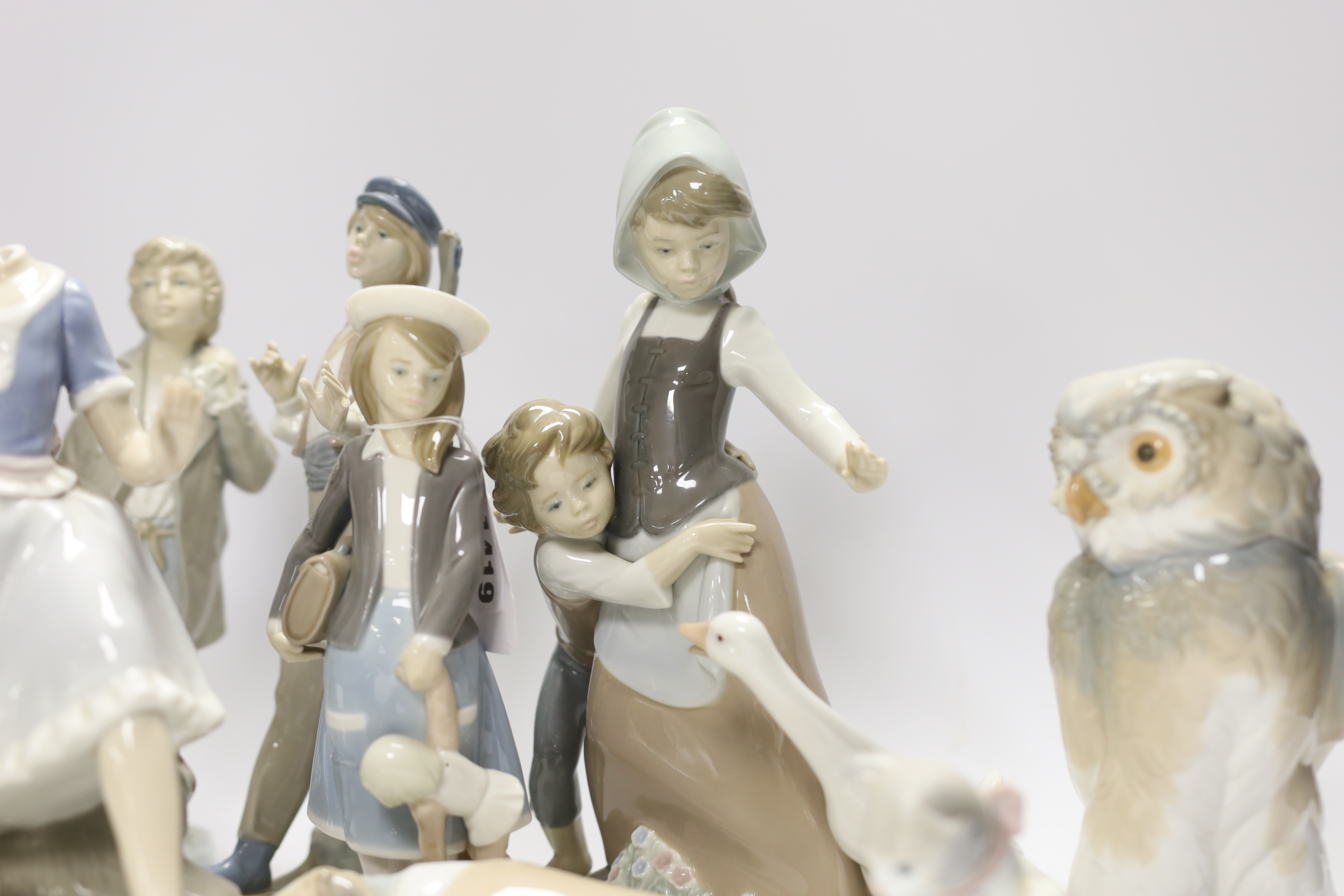 Ten Lladro and Nao figures including a short eared owl and a girl with braids, largest 26cm high